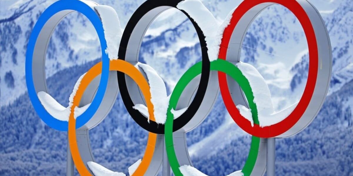 Winter Olympics Olympics sign with snow covering it
