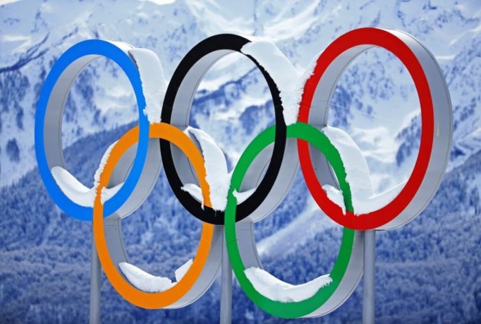 Olympics sign with snow covering it