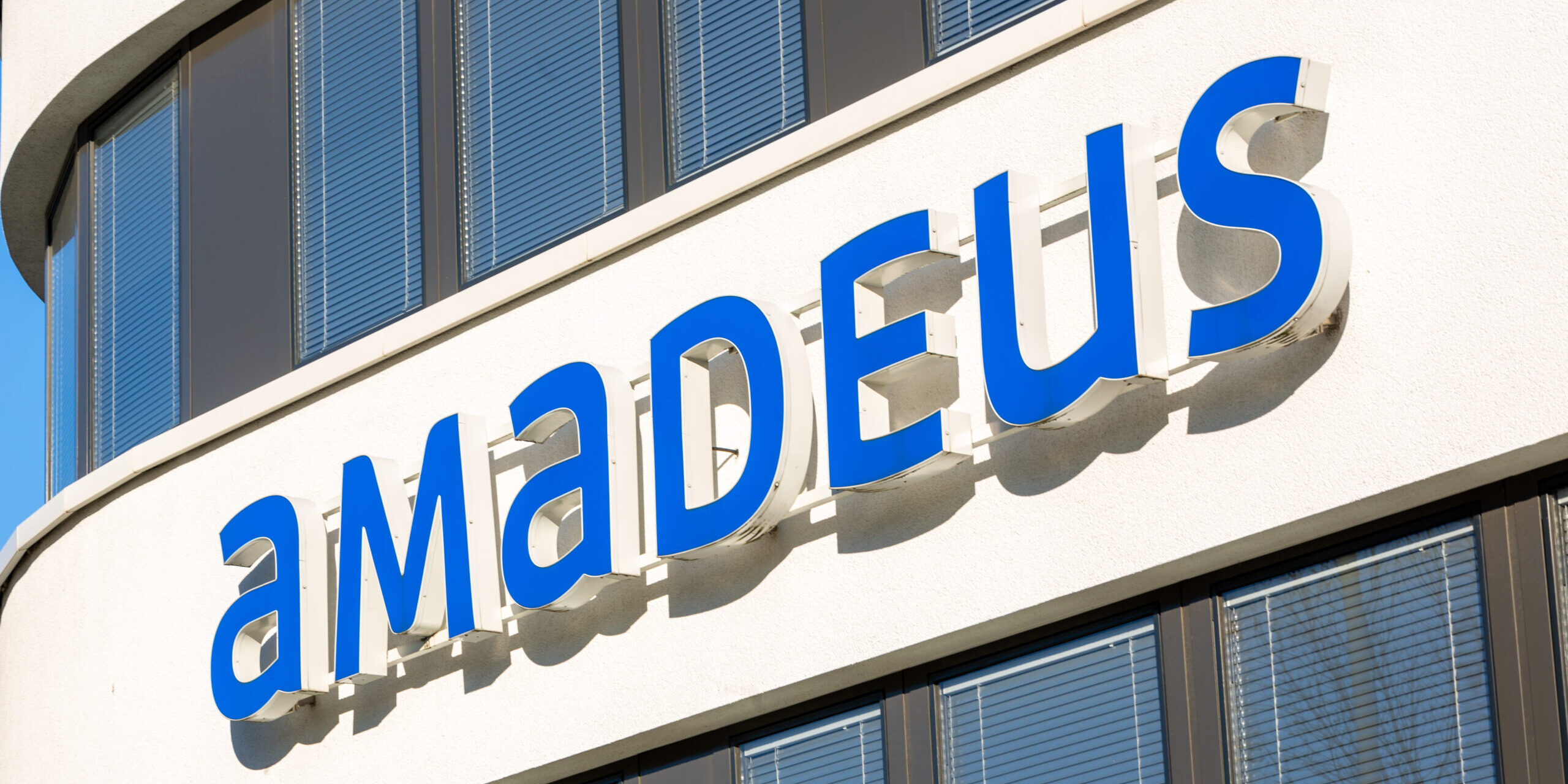 Company,Building,Facade,With,Logo,Of,Amadeus,With,Blue,Lettering